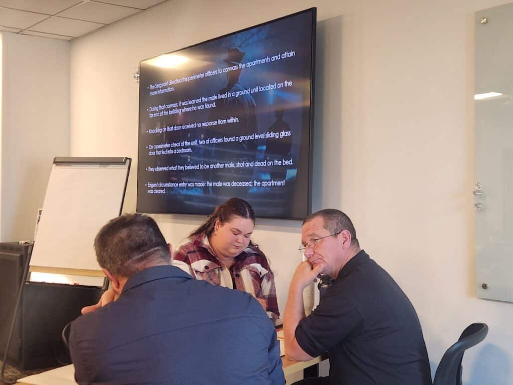corporate team working through a breakout session at a risk mitigation course